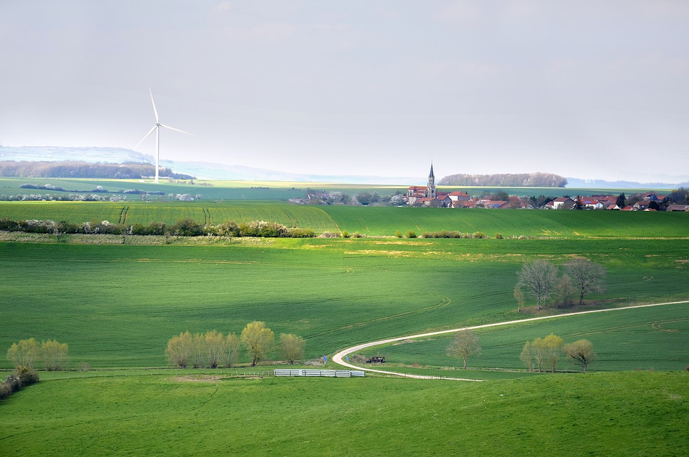 A wind turbine near a town.